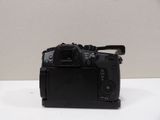a black camera sitting on a white table