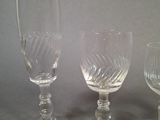 three empty wine glasses sitting on top of a table next to each other