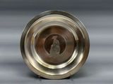 a silver plate with a picture of a person in it