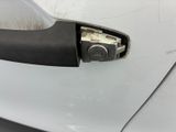 a close up of a door handle on a white car