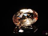 a close up of a fancy diamond on a black surface