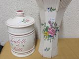 two vases on a table next to each other