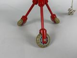 a red toy that is sitting on top of a table