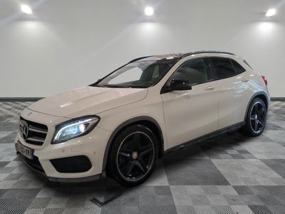 a white mercedes gla suv parked in a showroom
