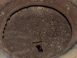 a close up view of a rusted pot with a hole in it