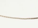 a close up of a silver chain on a white surface