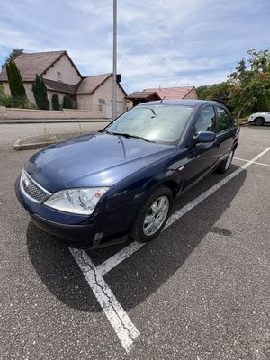 a picture of a blue car parked in a parking lot