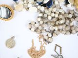 a white table with a bunch of jewelry on it