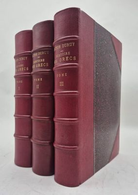 trois livres rouges superposés sur une surface blanche