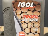 the bottle of log oil is sitting on the table next to a pile of logs
