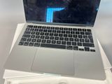 a laptop computer sitting on top of a white box
