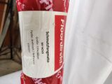 a roll of red wrapping paper on a white table