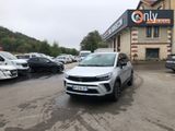 the car is parked in front of the building on the lot