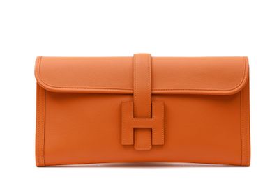 an orange leather clutch bag with a metal clasp