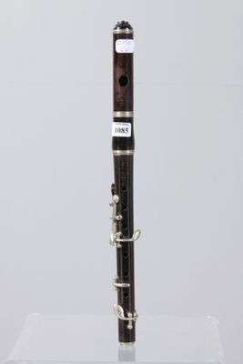 a close up of a clarinet on a clear surface with a white background