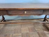 a wooden table with a drawer underneath it on a hard wood floor