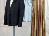 a suit and a skirt on a mannequin stand