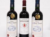 trois bouteilles de vin posées l'une à côté de l'autre sur une table