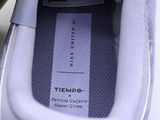 a close up of a pair of shoes with a tag on them
