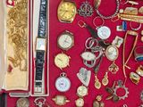 many different types of watches and other items in a case