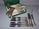 a green case with silverware in it on a table
