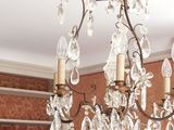 a chandelier hanging from the ceiling in a living room