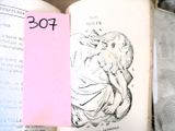 un livre ouvert sur lequel est collé un autocollant rose