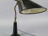 a black desk lamp with a black shade on top of it