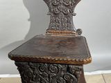 a wooden chair that is sitting on a tile floor