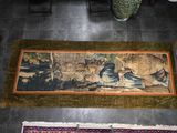 two rugs on the floor with a painting on them