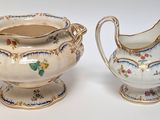 two small vases that are sitting next to each other