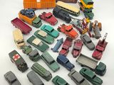 a lot of toy cars and trucks on a white surface