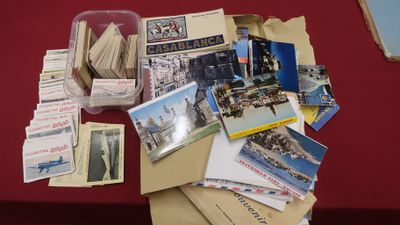 a pile of postcards on a table with a red table cloth