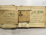 an open book with a bunch of stamps on it sitting on top of a table