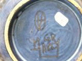 a close up of a blue vase with writing on it