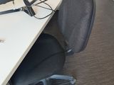 a desk with a computer and a chair in front of it