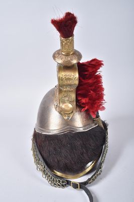a silver helmet with a red feather on top of it