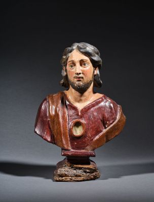 a wooden bust of a man with a beard and a red shirt