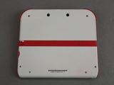 the back of a white and red nintendo wii game console