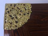 a wooden table with a gold decoration on it