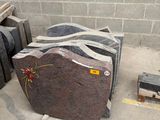 a pile of granite blocks in a room with a brick wall