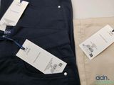 two men ' s pants with price tags on them sitting on a table