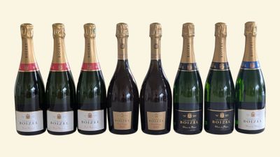 six bottles of champagne are lined up in a row