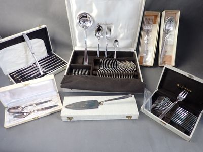 many silverware items in a case on a table