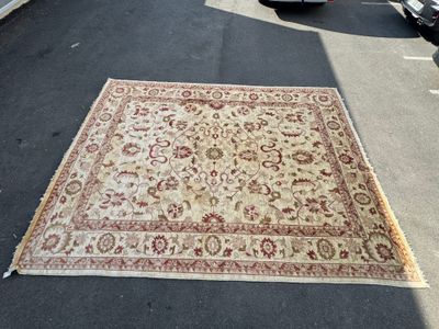 a large rug on the ground in the parking lot