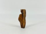 an image of a wooden sculpture of a person standing on a white surface