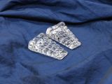 two pieces of clear plastic sitting on top of a blue cloth
