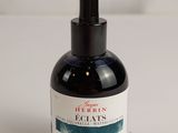 a bottle of ink sitting on top of a white table