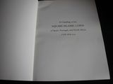an open book with a picture of a square islamic coin on it