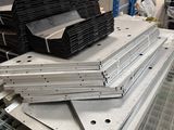 several pieces of metal are stacked on top of each other in a warehouse